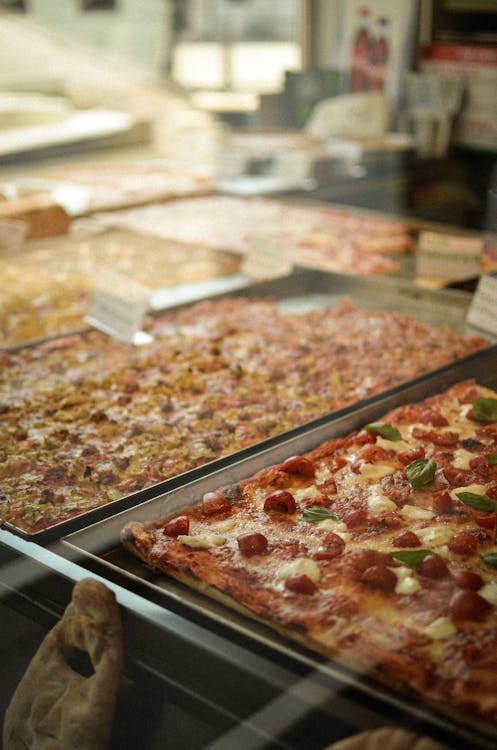 Close-up of Different Kinds of Pizzas on Display 