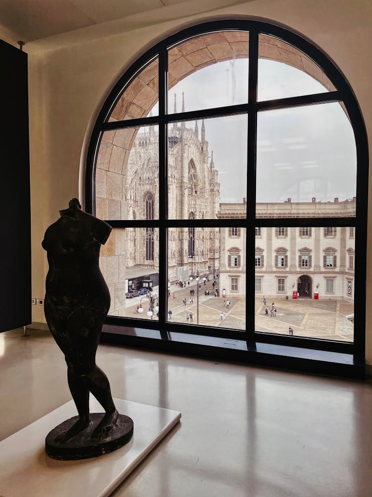 Statue In Front Of The Window In A Museum 