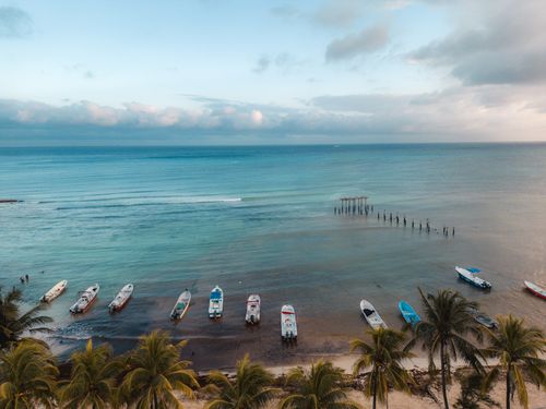 Free Serene scene of boats moored at a tropical Playa del Carmen beach, perfect for travel enthusiasts. Stock Photo