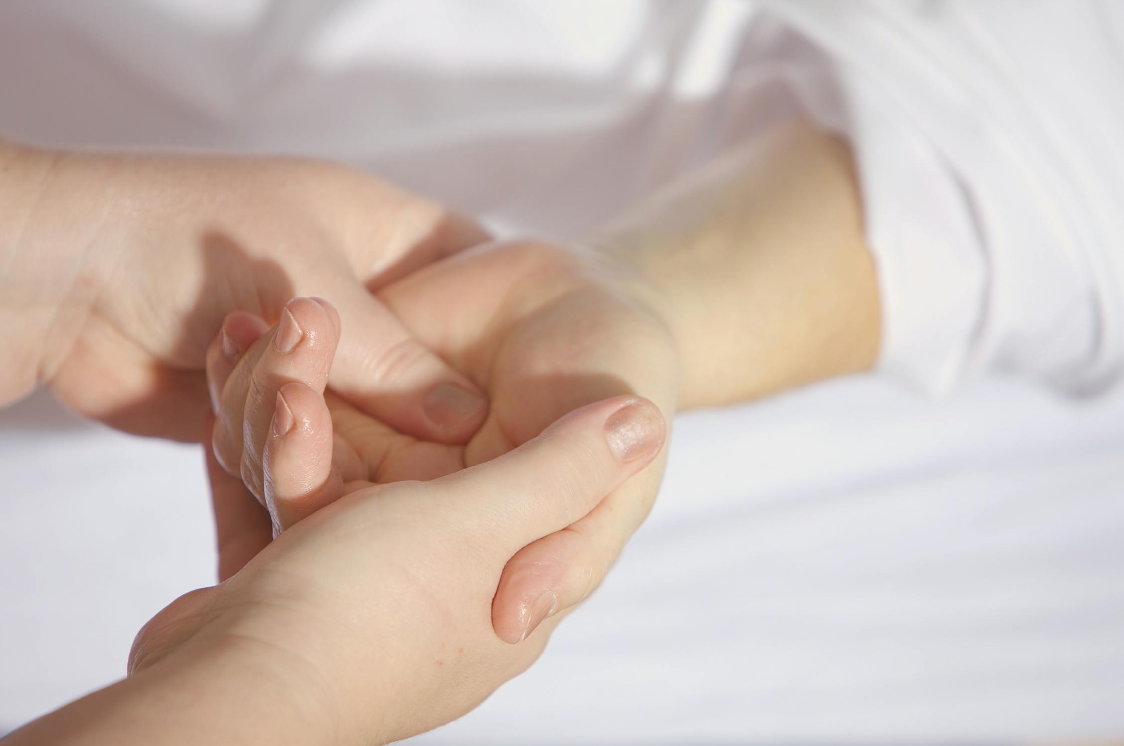  Person getting a hand massage. 