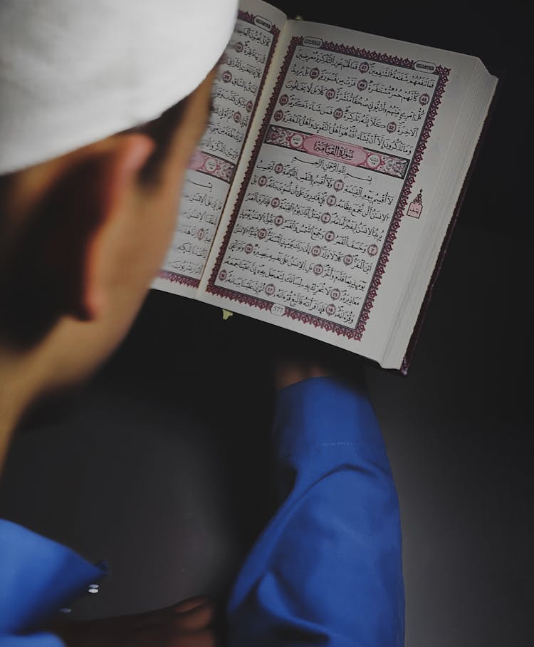 Man Reading The Koran