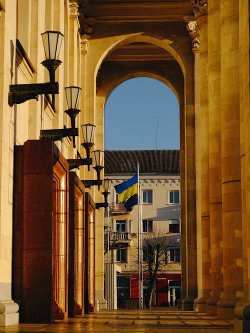 Ukrainian Flag behind Building Columns