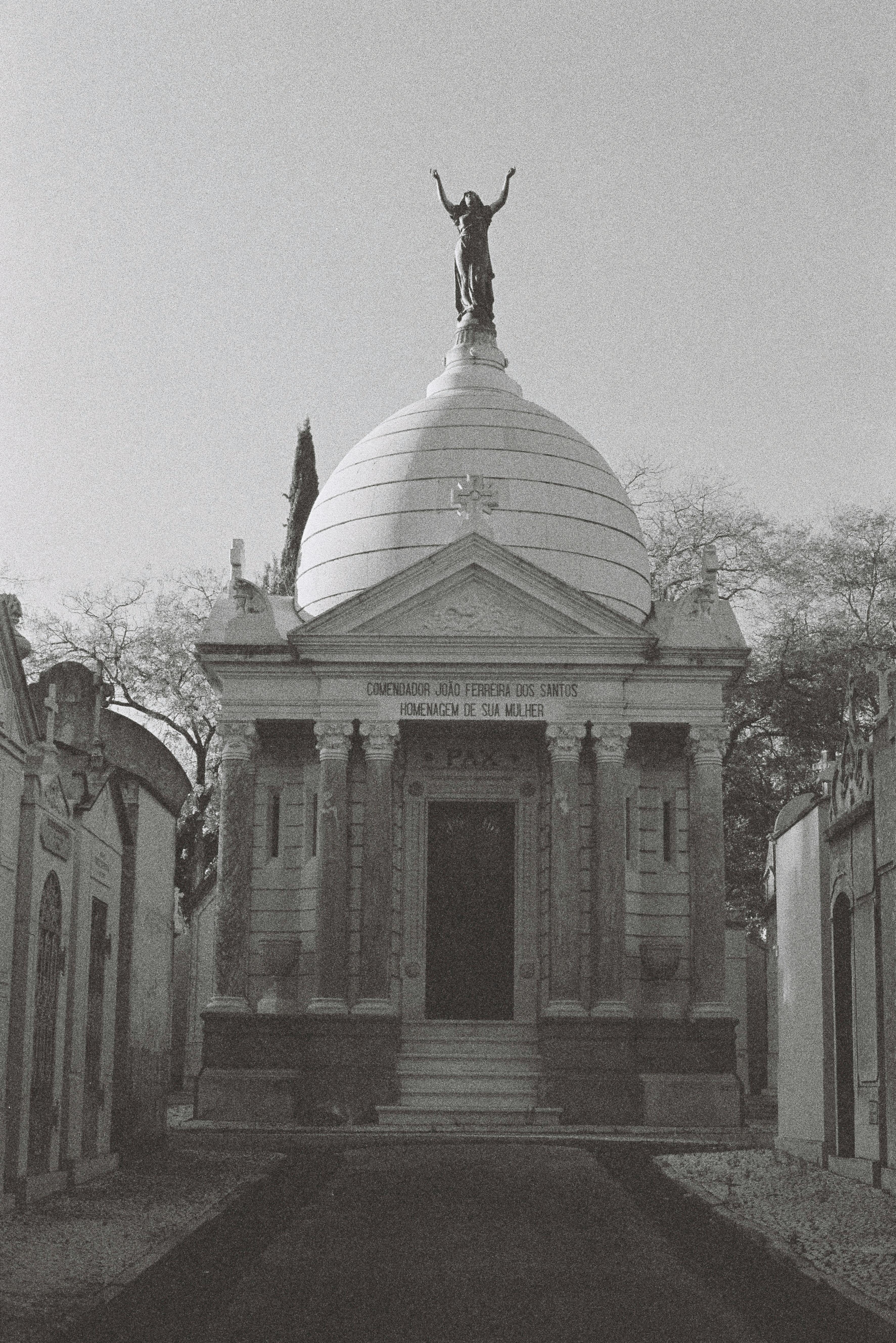 Black and white image of a historic chapel with a dome at Alto de São João Cemetery in Lisbon, Portugal.
