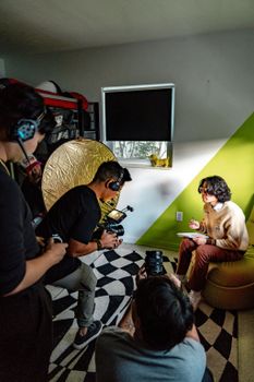 Capturing a photo session with a model in a well-lit creative indoor studio.