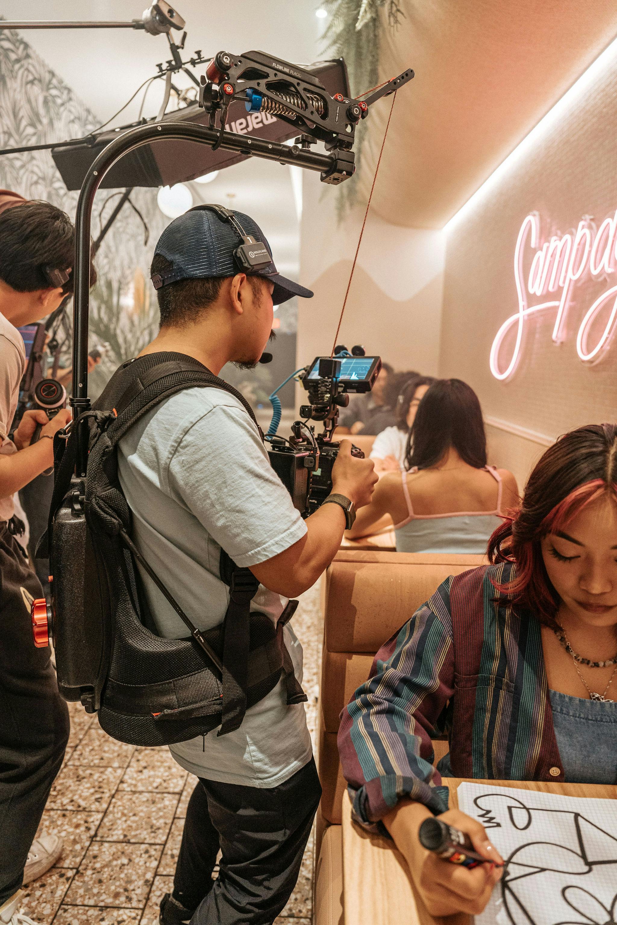 photographer filming woman at cafe