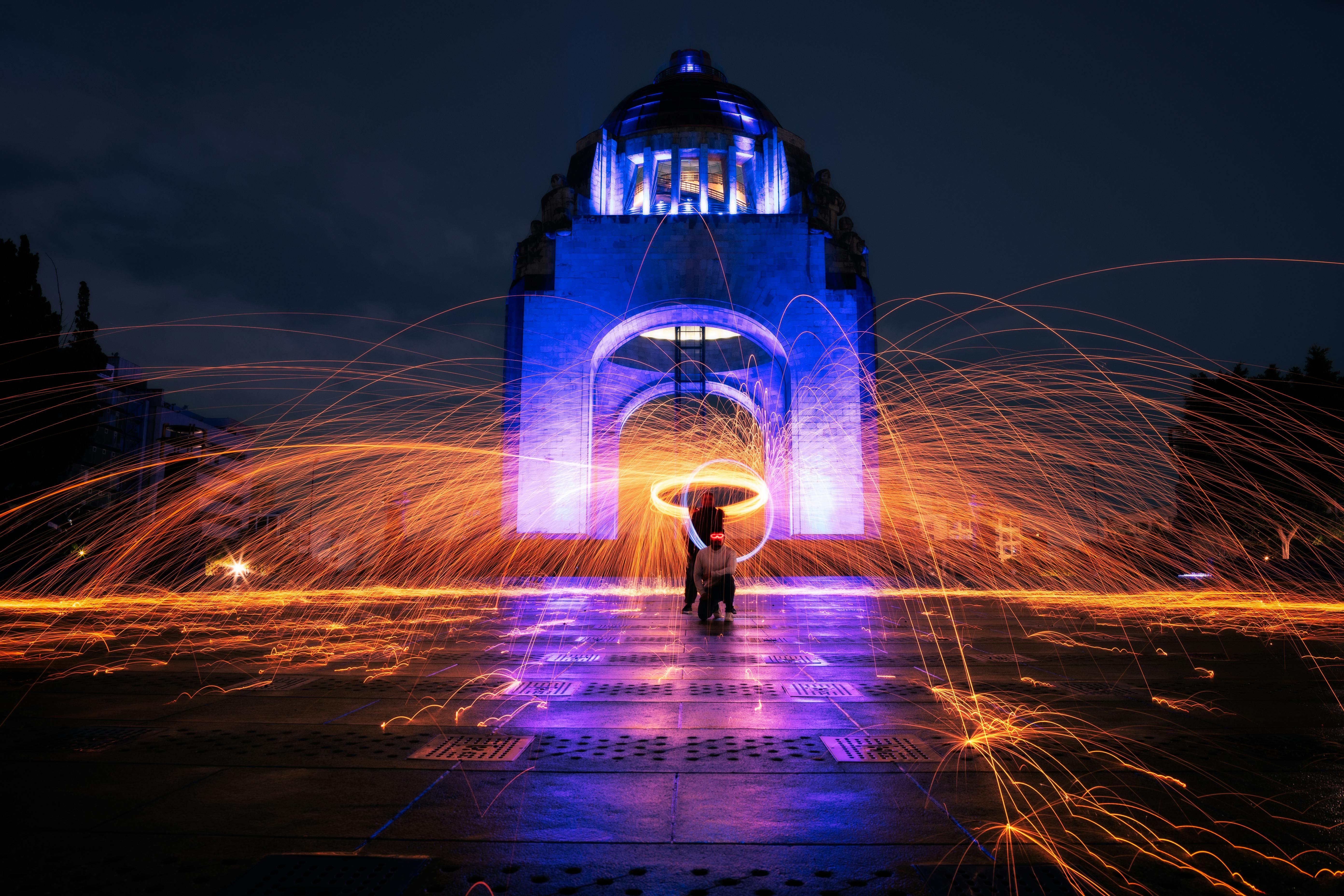 Dynamic light painting at the Monument to the Revolution in Mexico City during the night.