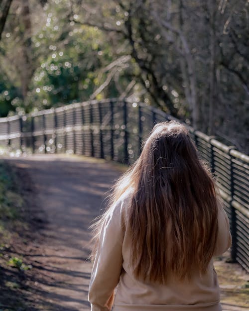 Woman on Footpath near Trees