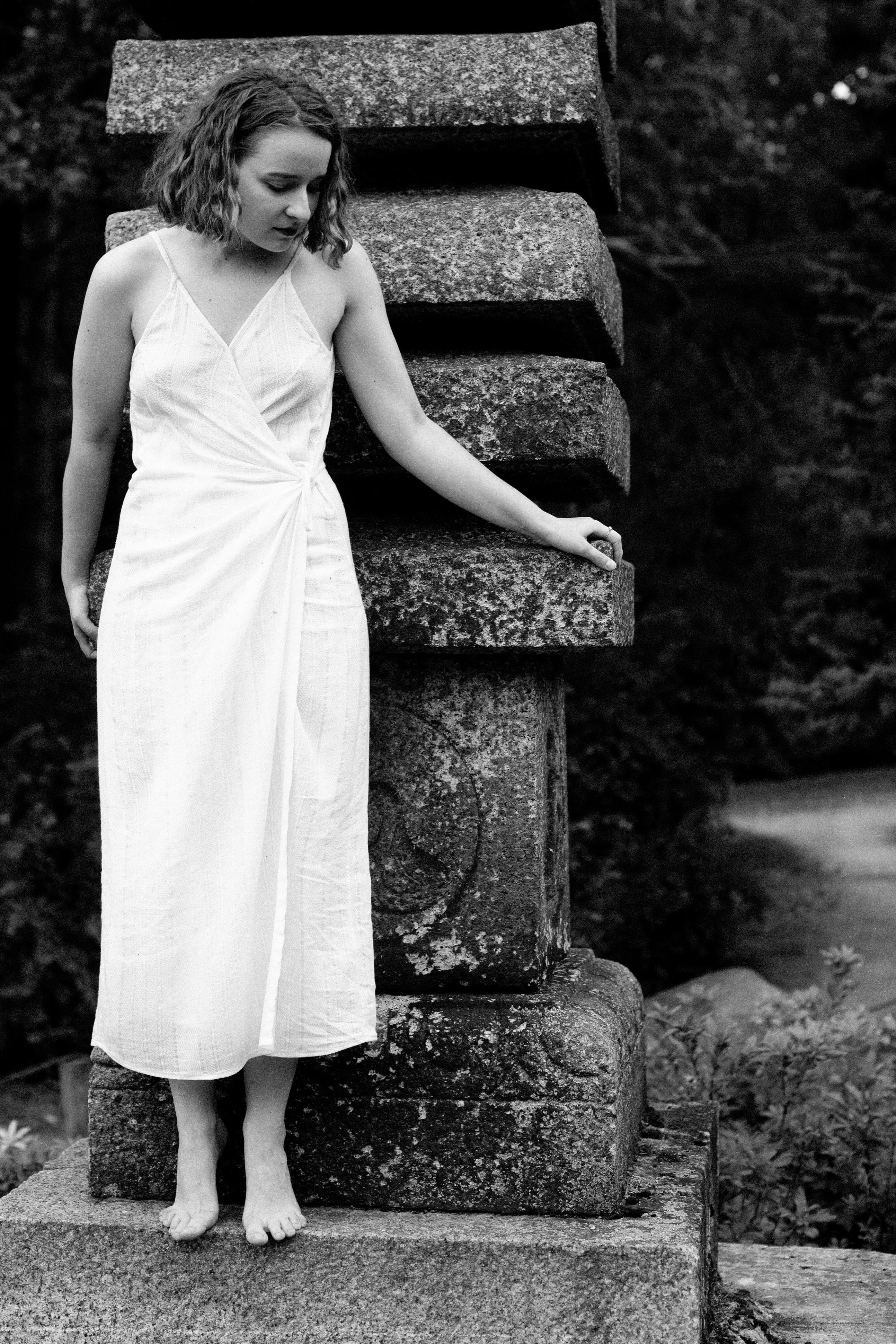 Stylish black and white portrait of a woman in a white dress in Moscow, Russia.