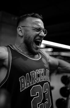 Intense black and white portrait of a man working out in a gym.