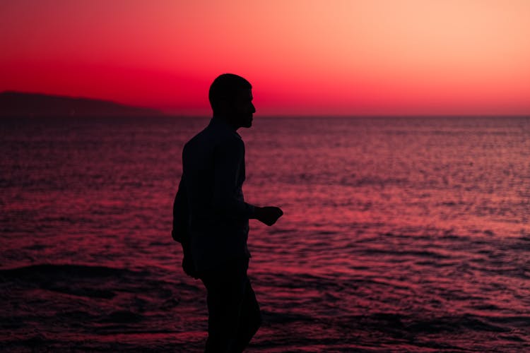 A Silhouette Of A Man In Sunset