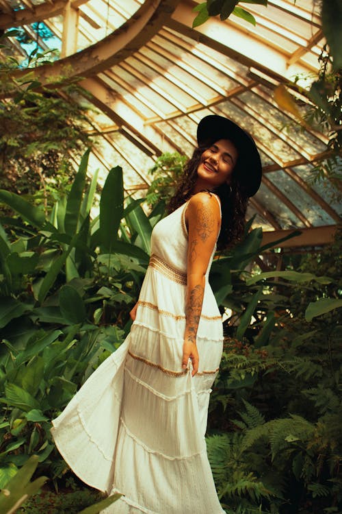 Woman in Dress in Greenhouse