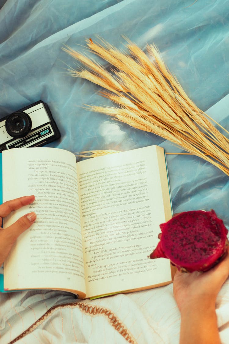 Woman Reading Book And Eating Dragonfruit