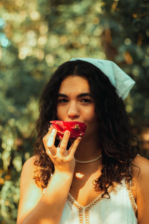 Portrait of Beautiful Woman Eating Dragonfruit