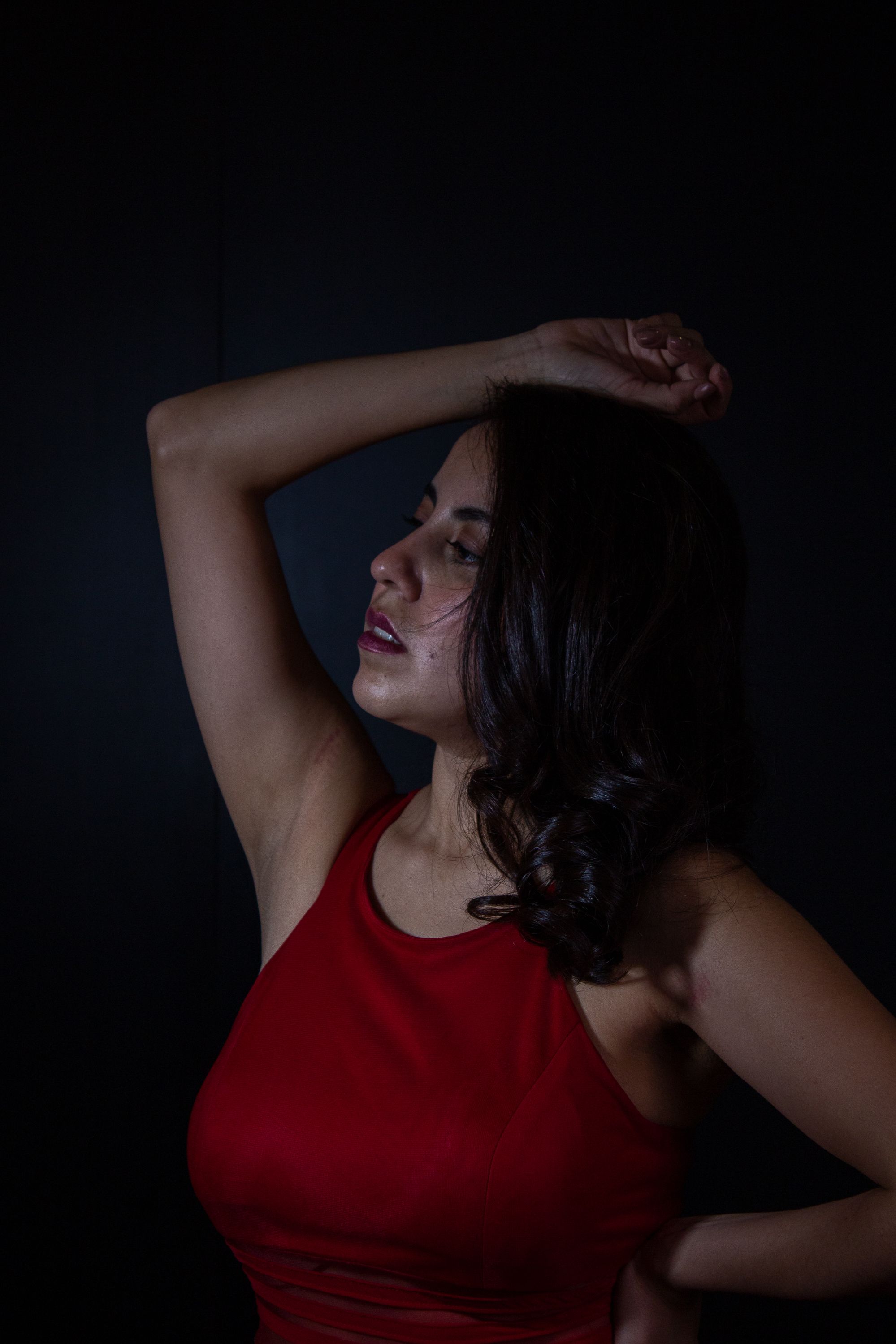 Portrait of a Woman in a Dark Room · Free Stock Photo