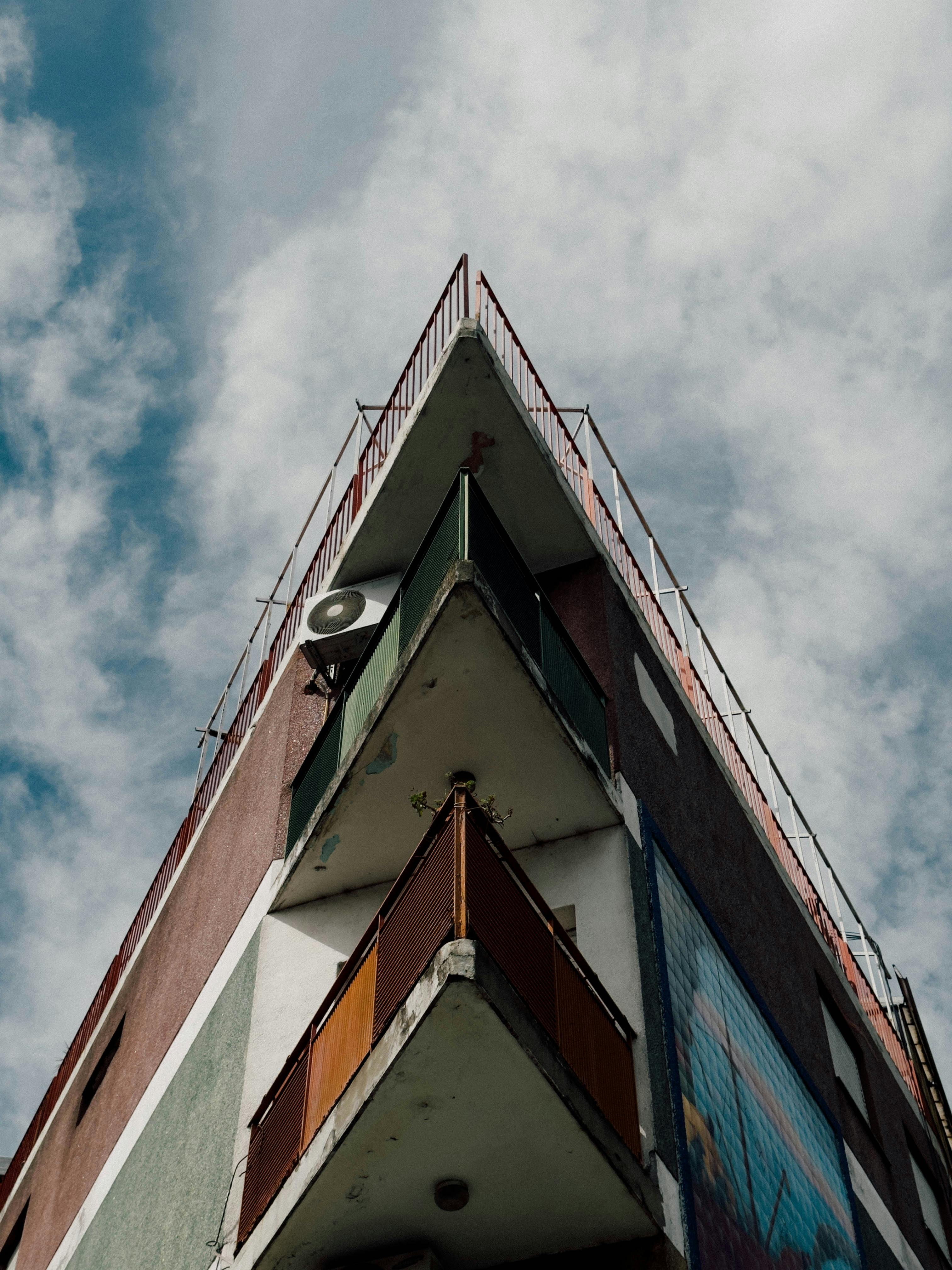 Free Dramatic angle of a geometric building in Buenos Aires with balconies against a clouded sky. Stock Photo