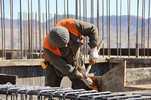 Construction Worker Working with Hammer