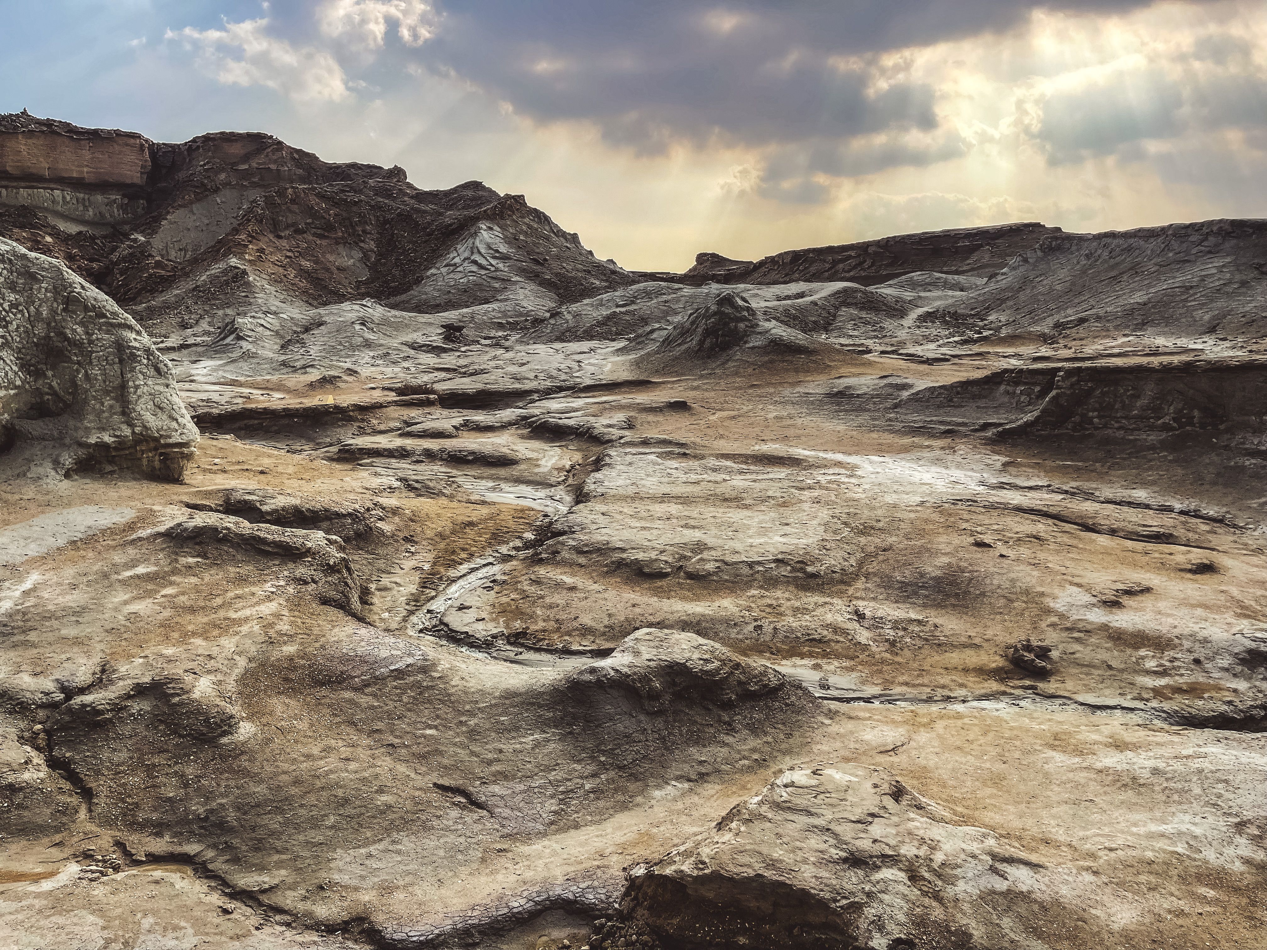 Explore the rugged and barren desert terrain on an island in Iran.