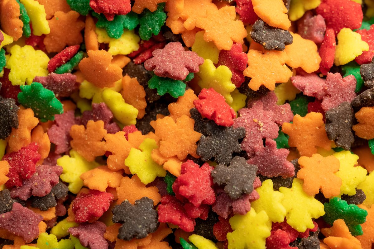 Close-up of colorful leaf-shaped candy sprinkles, perfect for fall-themed desserts.