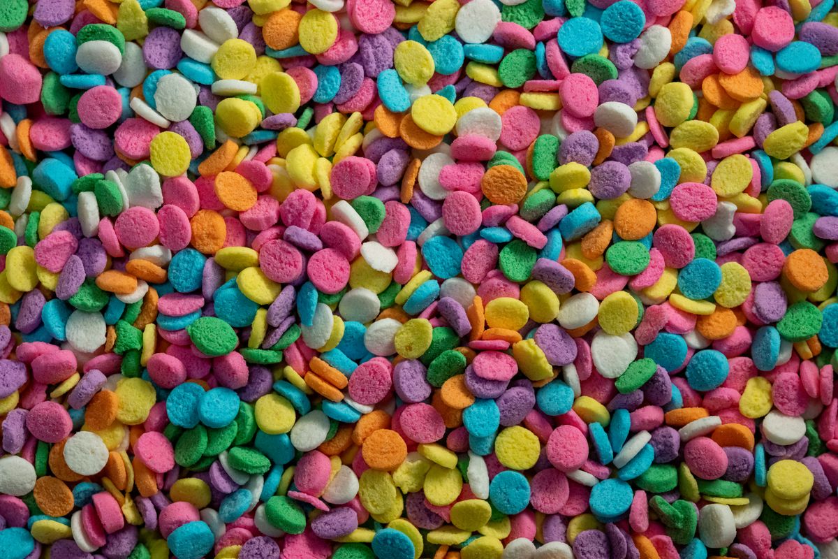 A vibrant collection of colorful round candies in various shades, creating a cheerful aesthetic.