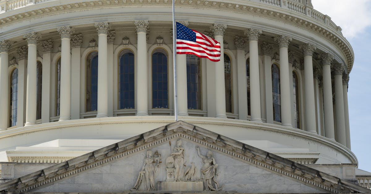 Photo by David Dibert Close-up of the Capitol building in Washington DC with the US flag waving in front.