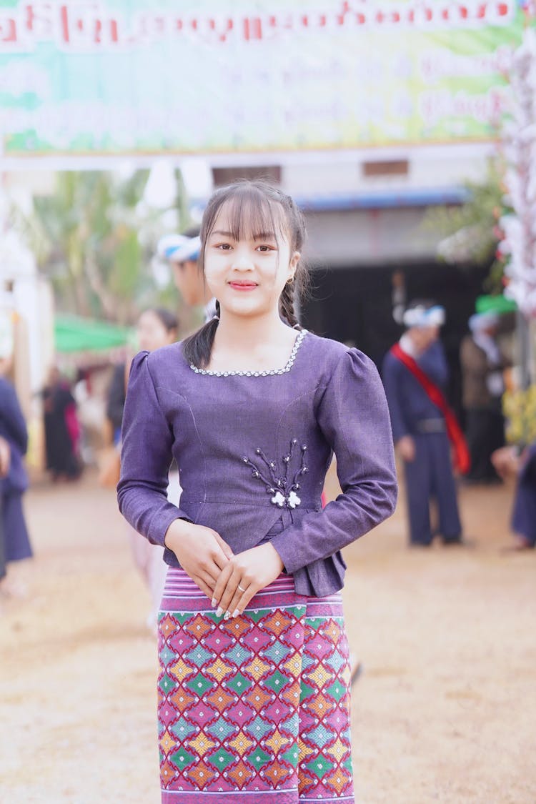 Woman Posing In Purple Clothes And Skirt