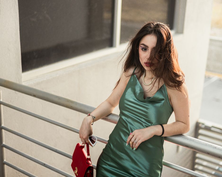 green dress red bag A guest is seen wearing green dress, red bag, boots outside Coperni... News Photo