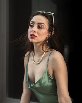 Portrait of a fashionable woman wearing artistic makeup and a satin dress, exuding elegance and style.