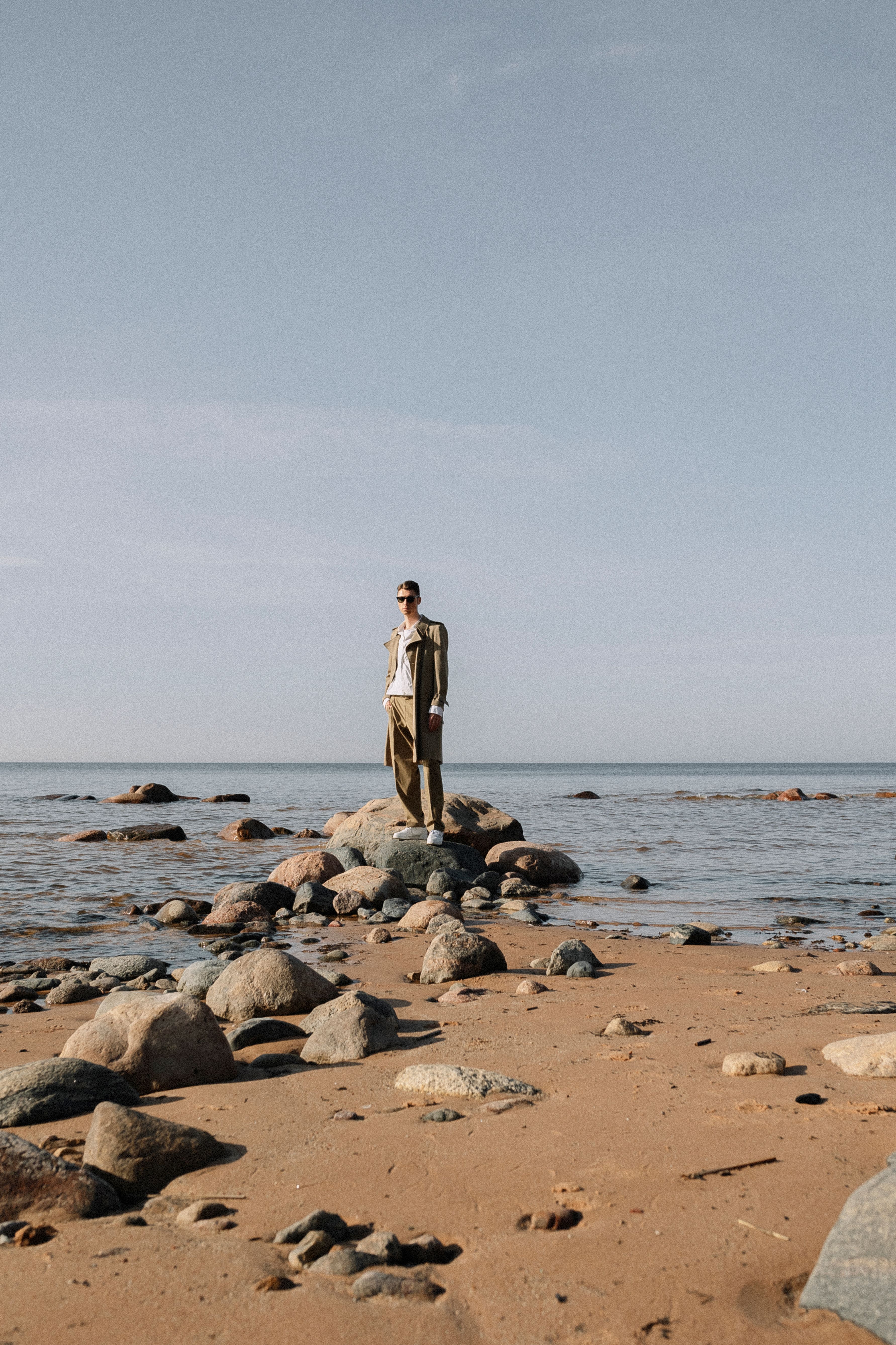 Man Standing on Rocks on Beach · Free Stock Photo