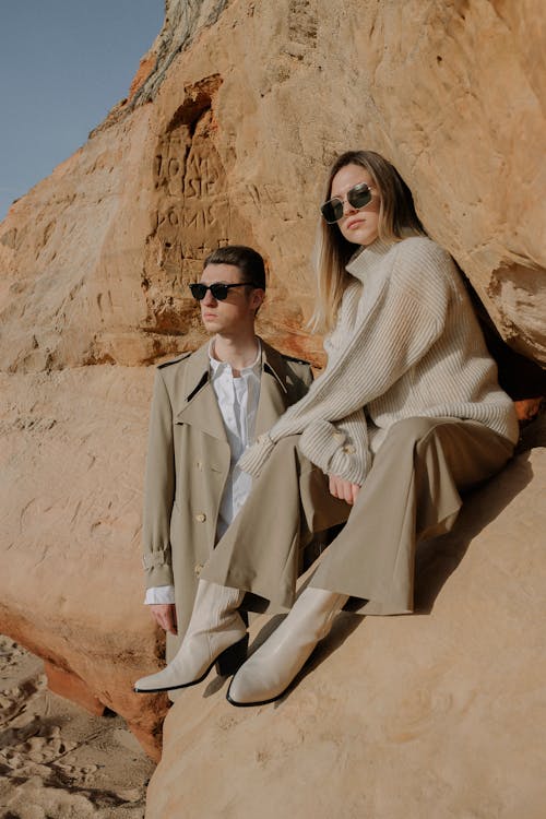 Two Models Posing in Front of a Sandstone Rock Formation