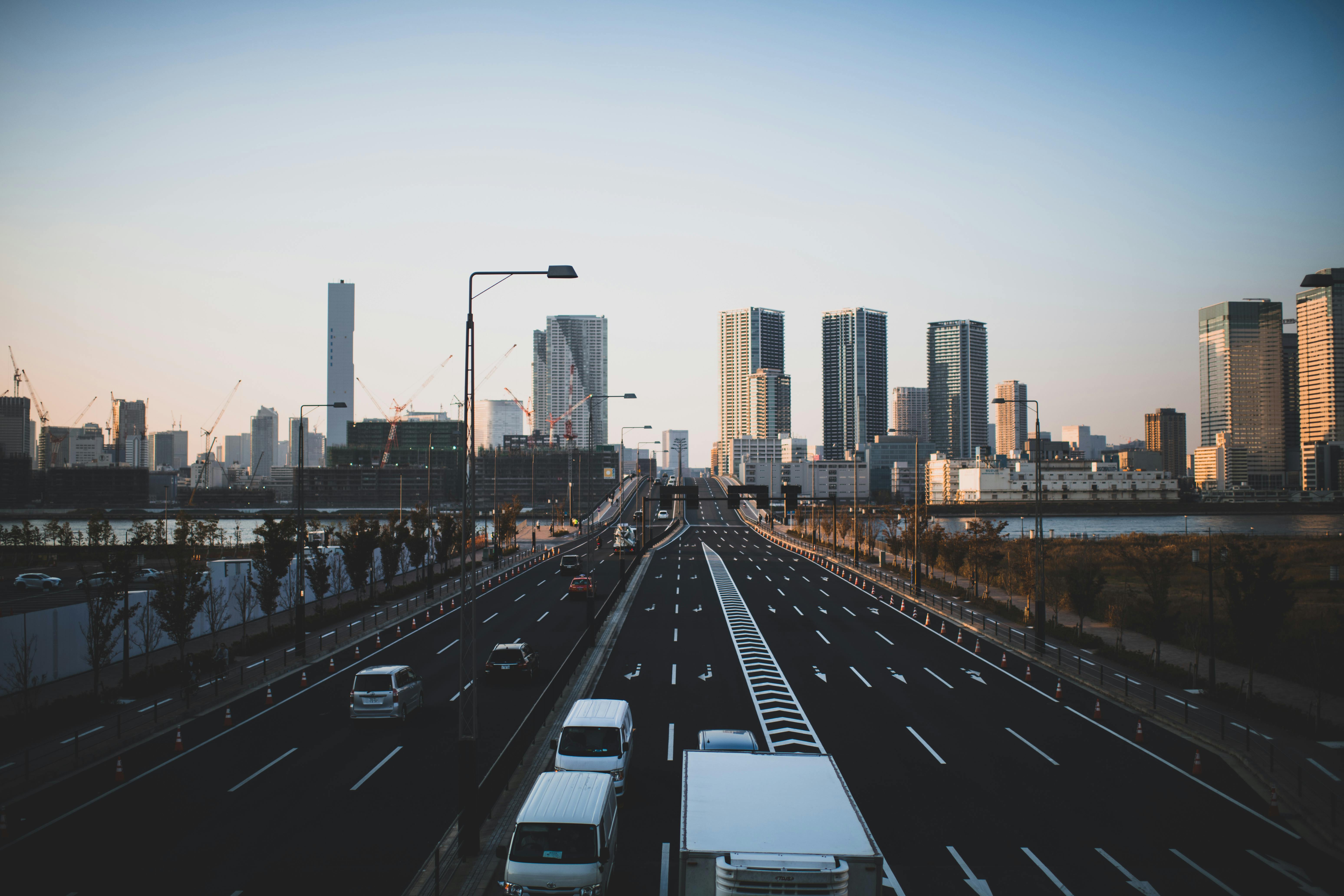 广角镜头捕捉了日落时分摩天大楼与道路交织的城市景观，展现了现代建筑与交通的精髓