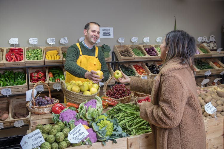 Woman Buying Food At The Greengrocers 