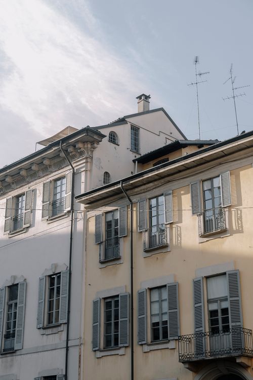 Free A view of traditional European residential facades with window shutters and sunny skies. Stock Photo