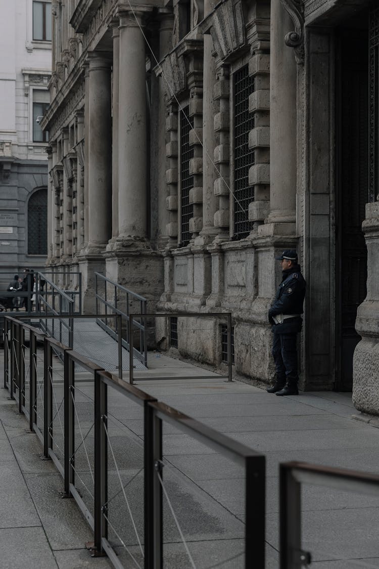 Guard Standing By Building Wall