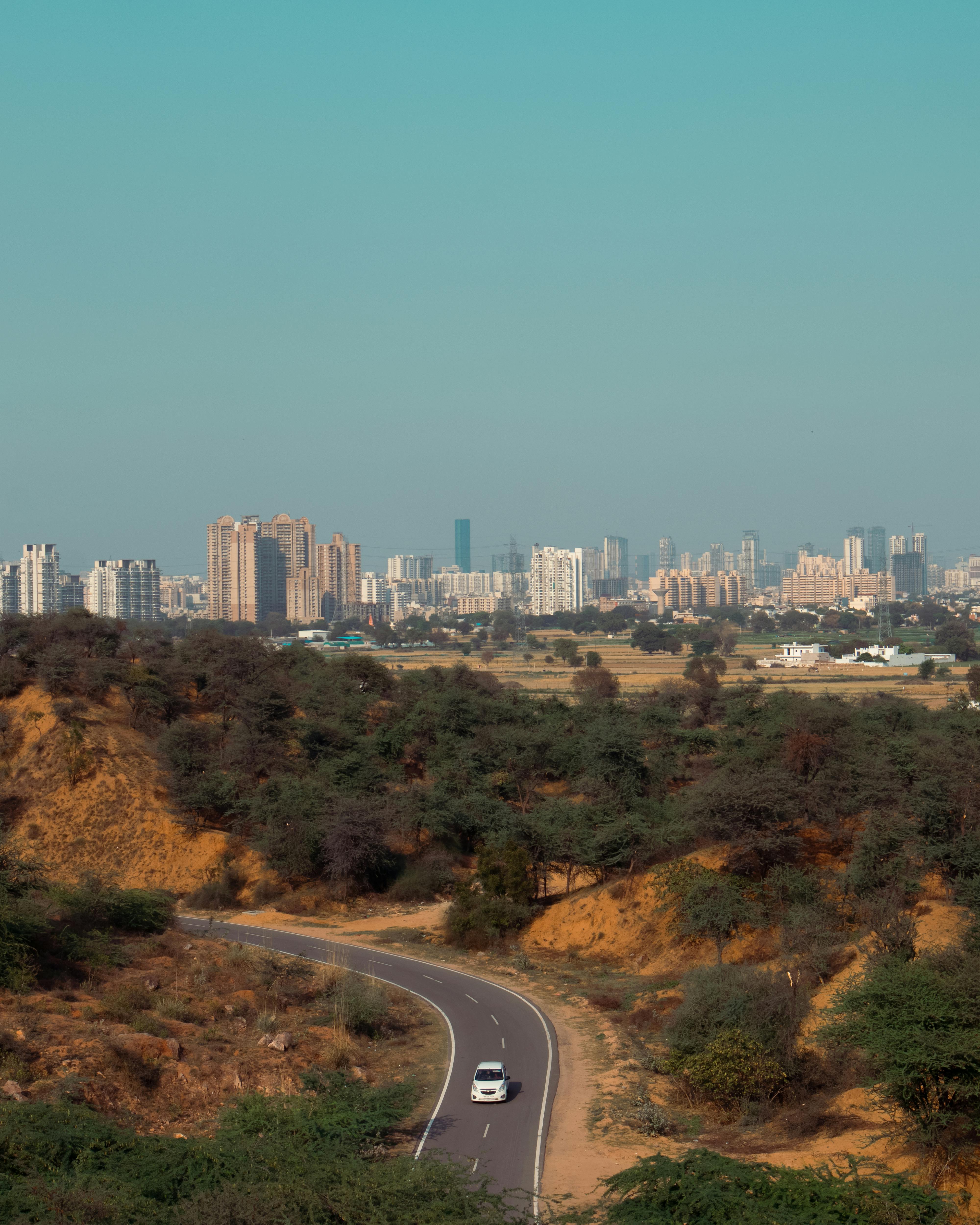 Panoramic skyline of Gurugram with clear blue skies and vibrant cityscape