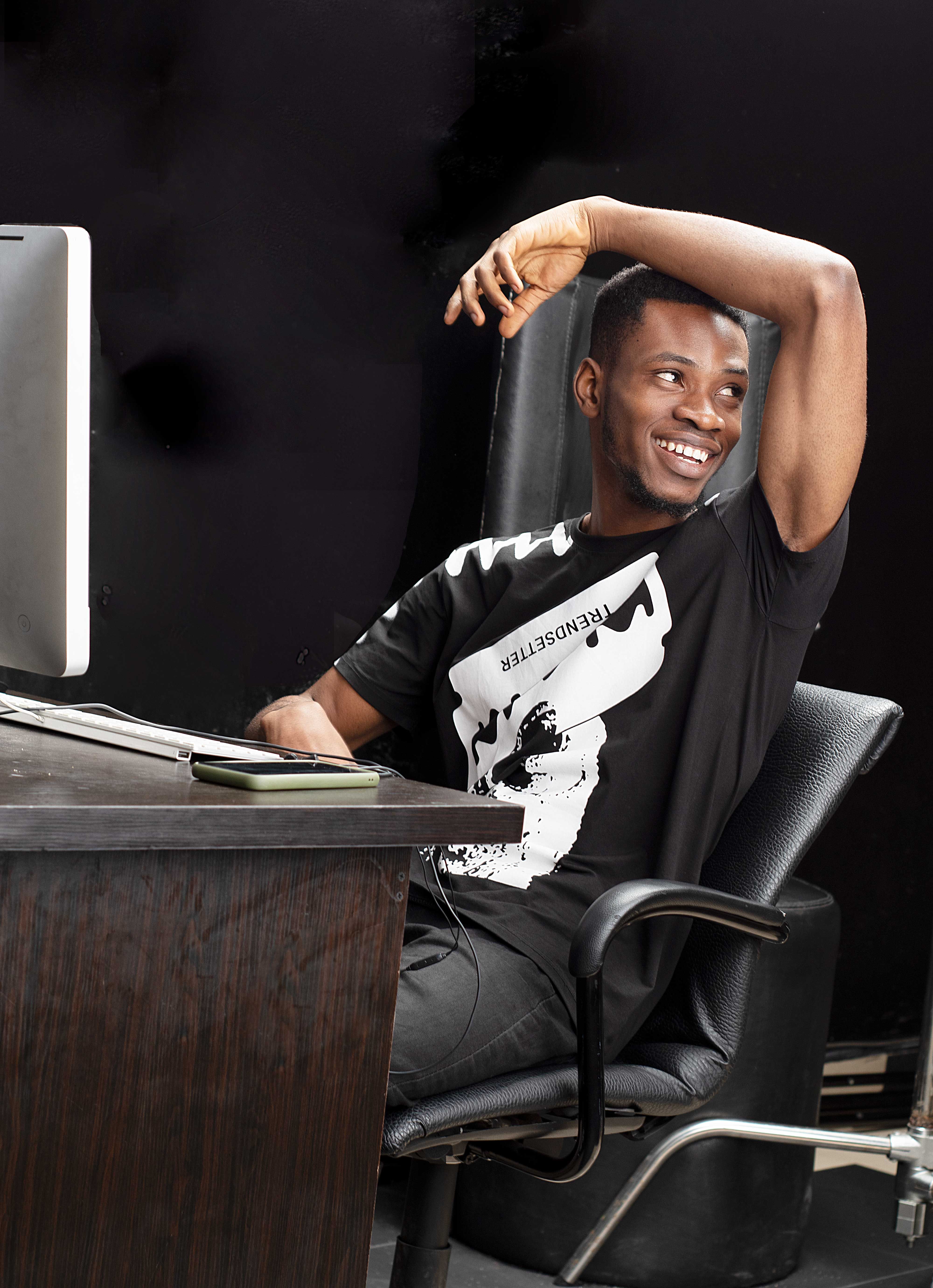 Man Sitting and Posing by Computer · Free Stock Photo