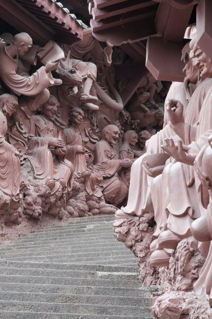 Detailed stone carvings of monks and figures in a temple, showcasing beautiful artistry.