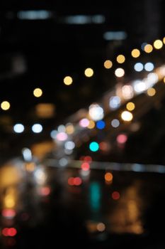 A vibrant display of blurred city lights creating a bokeh effect at night.