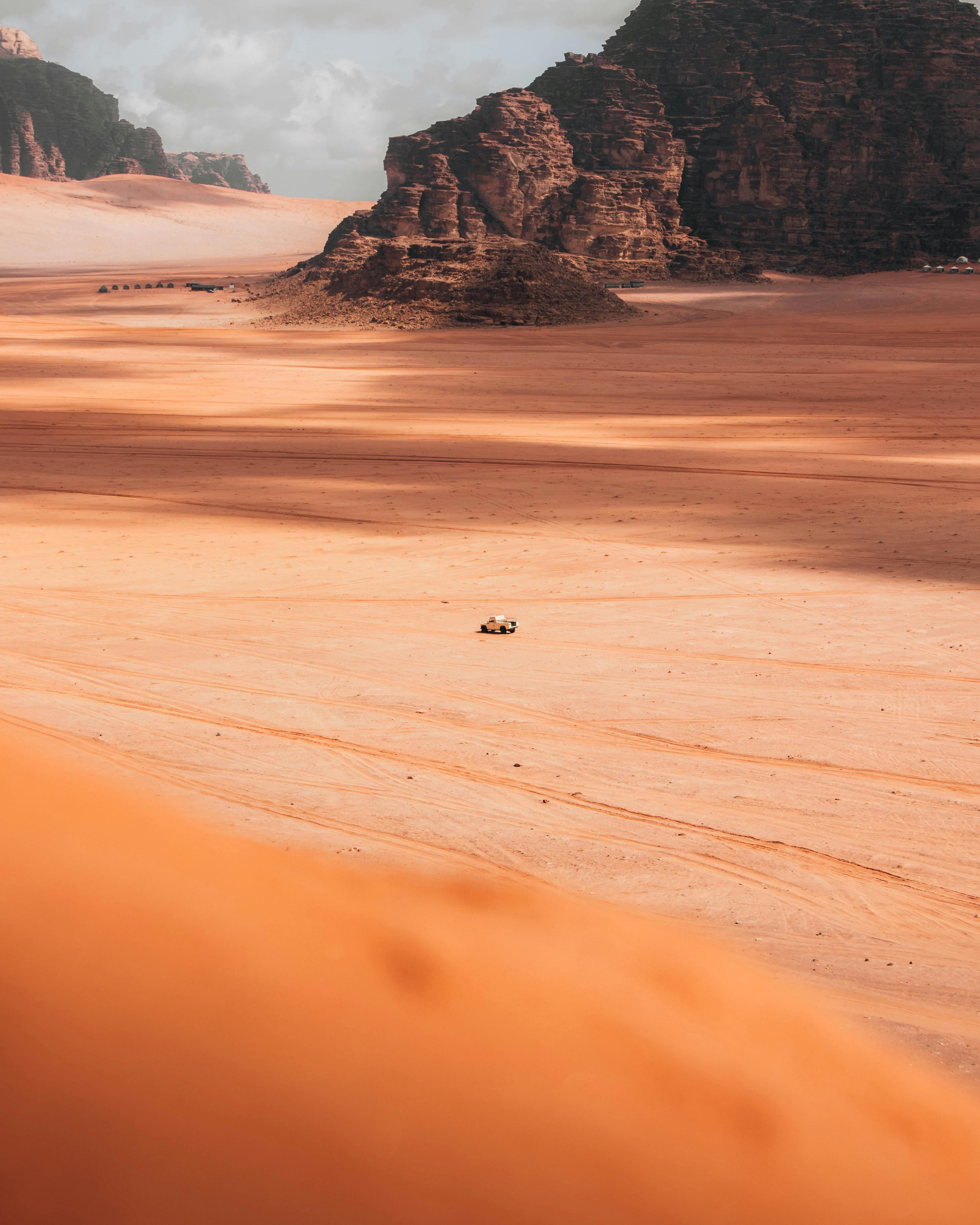 Stunning view of desert landscape in Wadi Rum, showcasing rock formations and vast sandy terrain.