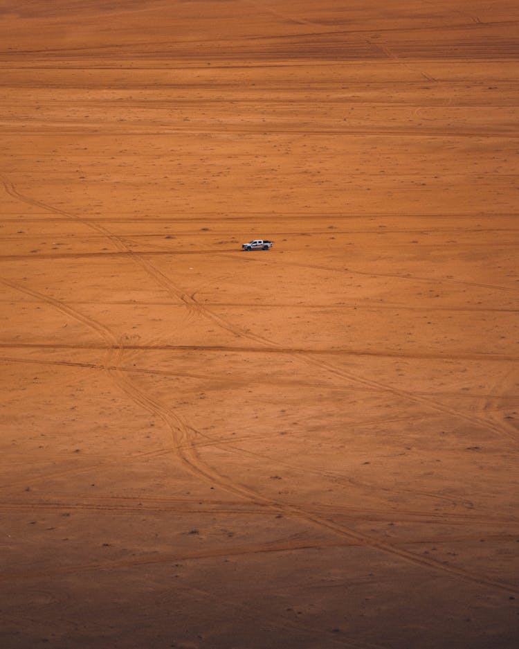 Car On Barren Desert