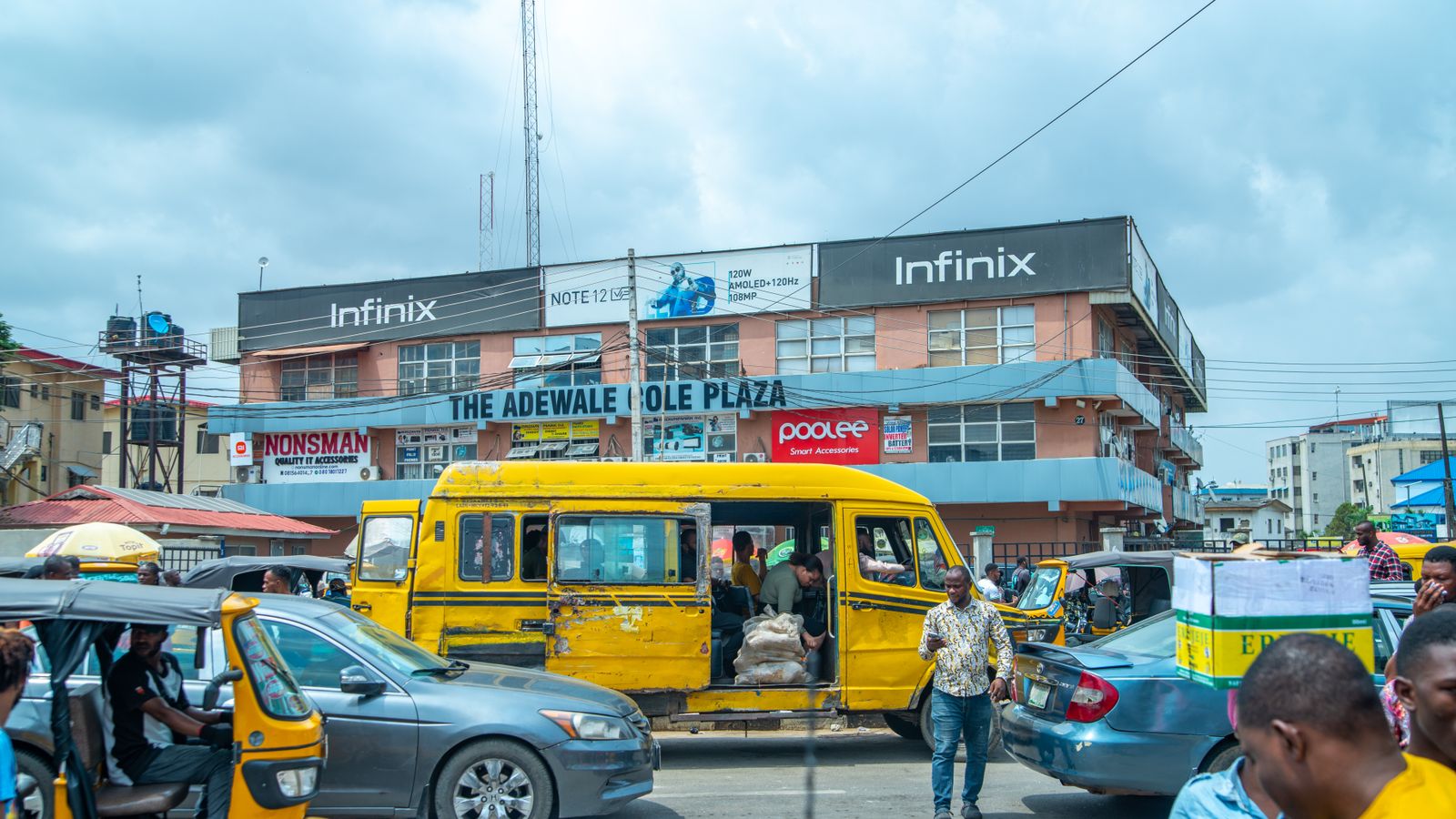 People and cars on city street, Nigeria