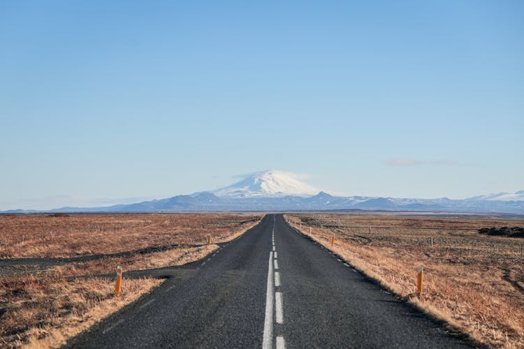 Road On Plains With Mountain Behind