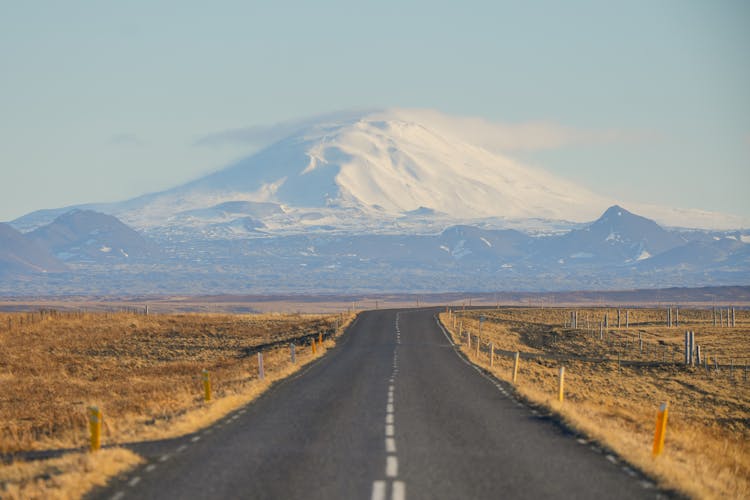 Empty Road Against Mountain On Horizon