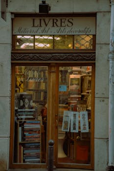 A cozy Parisian bookstore front showcasing vintage books and decorative arts. Perfect for book lovers.