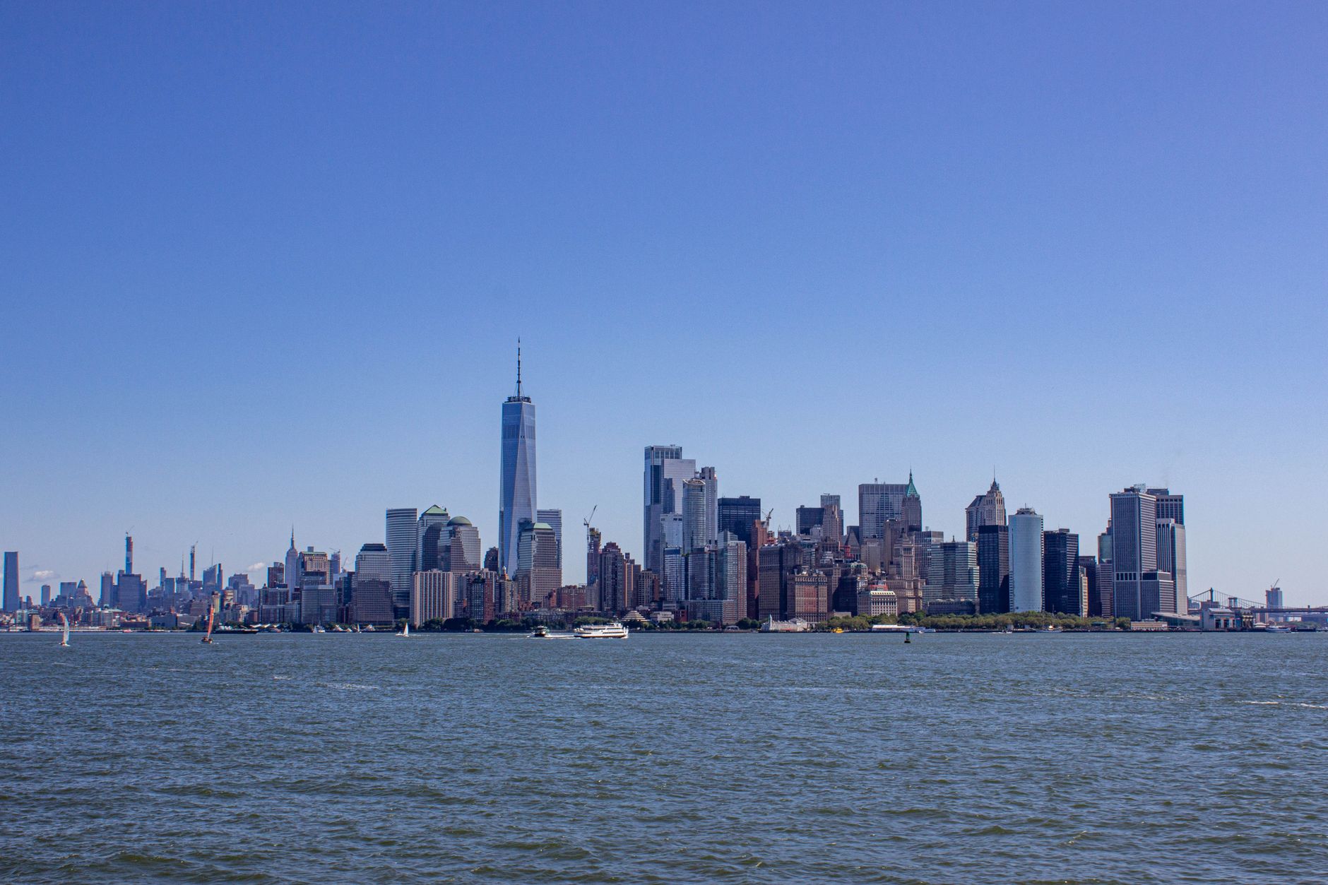 Stunning skyline of New York City with iconic skyscrapers under a clear blue sky.