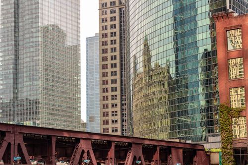 Free Modern urban architecture with reflections on glass facades showcasing city skyline. Stock Photo