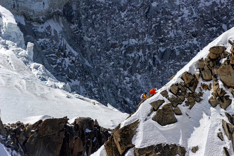 People Climbing On Majestic Mountain