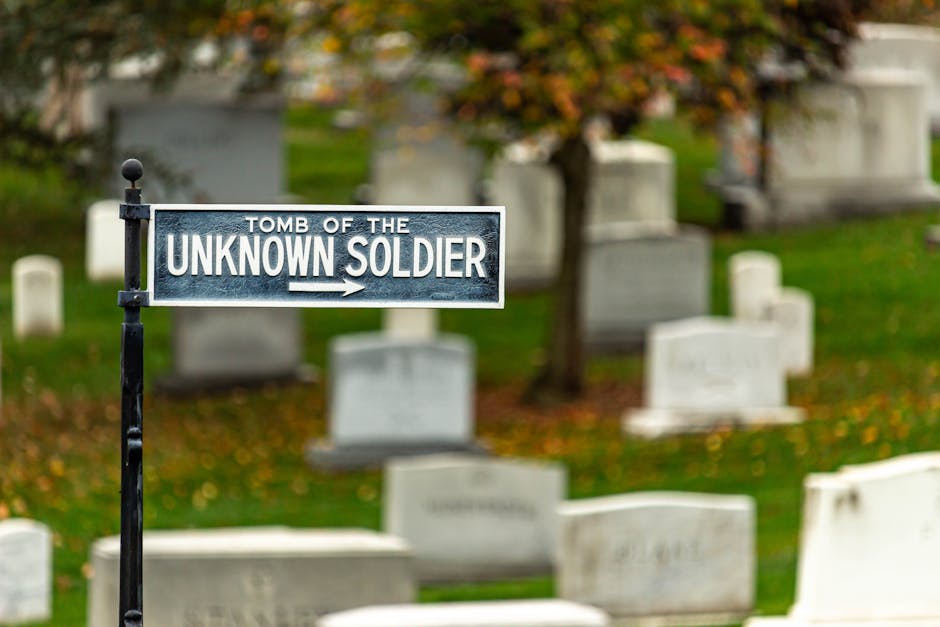 Sign pointing to the Tomb of the Unknown Soldier in Arlington National Cemetery during fall.