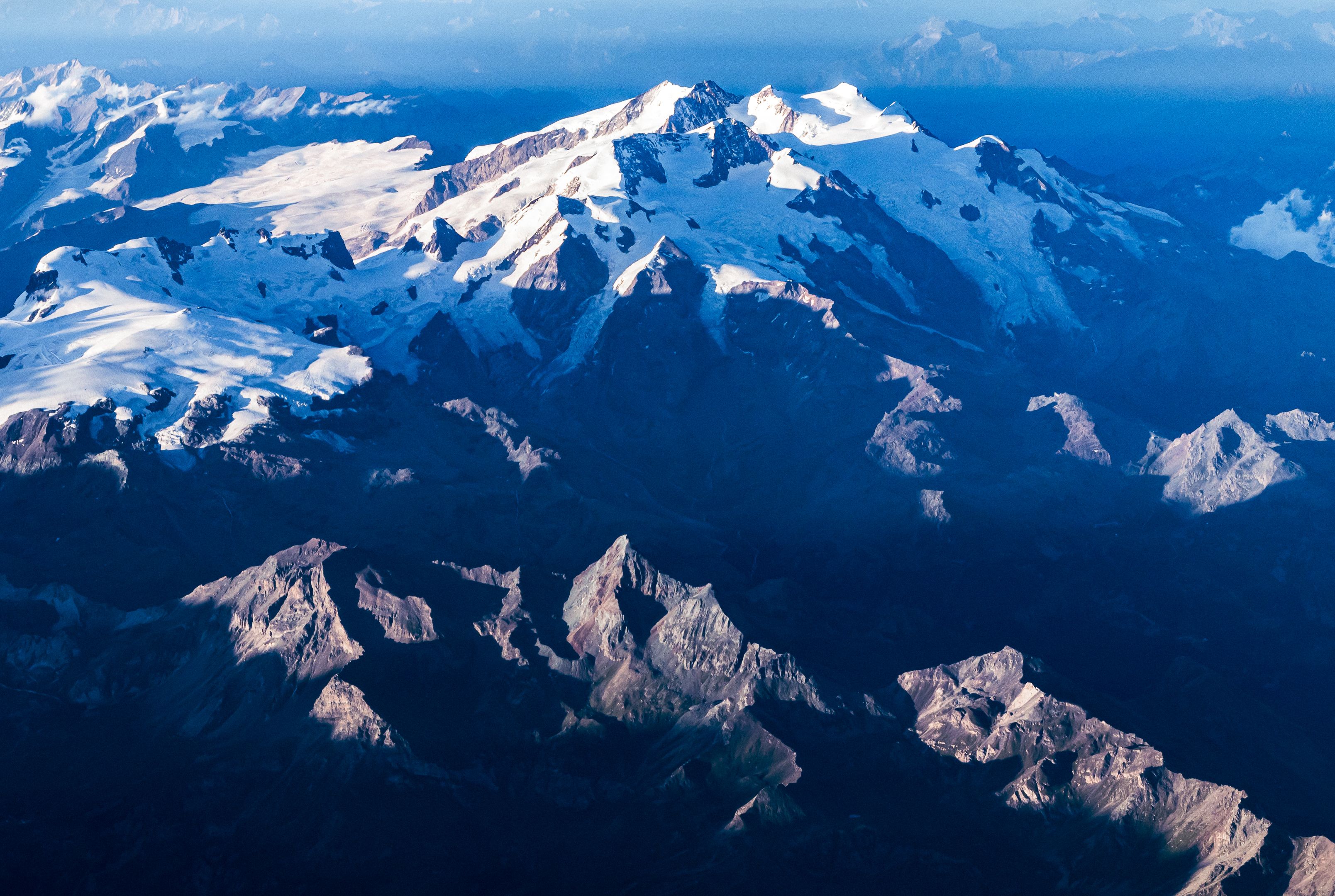 Bear Glacier Signature Helicopter Tour - Stunning aerial photography capturing snow-covered mountain peaks under a bright blue sky.