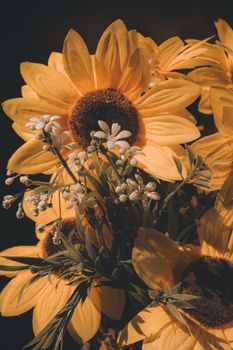 A close-up of sunlit sunflowers with white wildflowers, capturing summer's warmth.