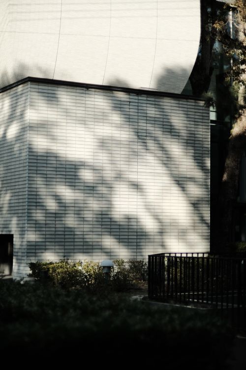 Free Minimalist building facade with shadow patterns outdoors in daylight. Stock Photo